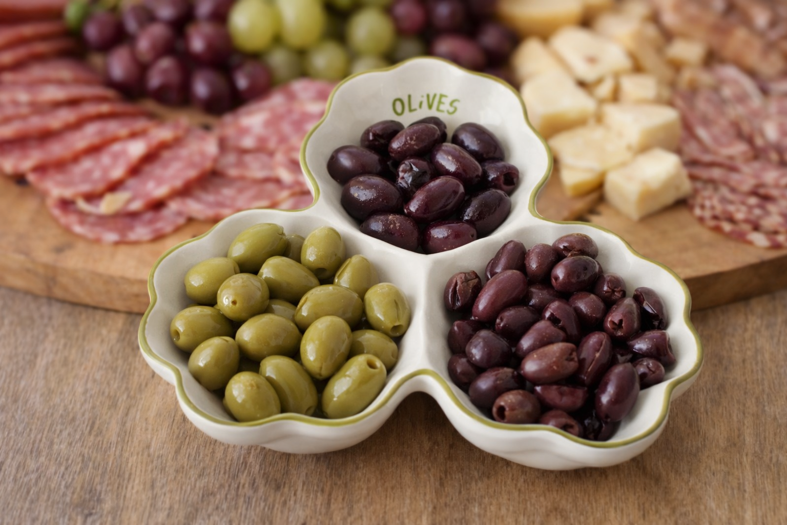 Olive platter with green and black olives on a light surface