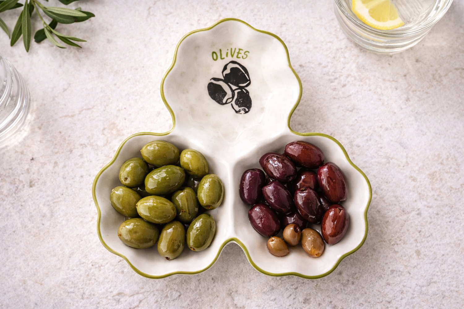 Olive platter with green and black olives on a light surface