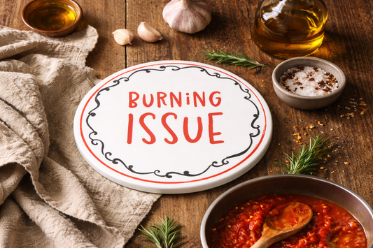 Wooden table  with italian trivet with cooking ingredients