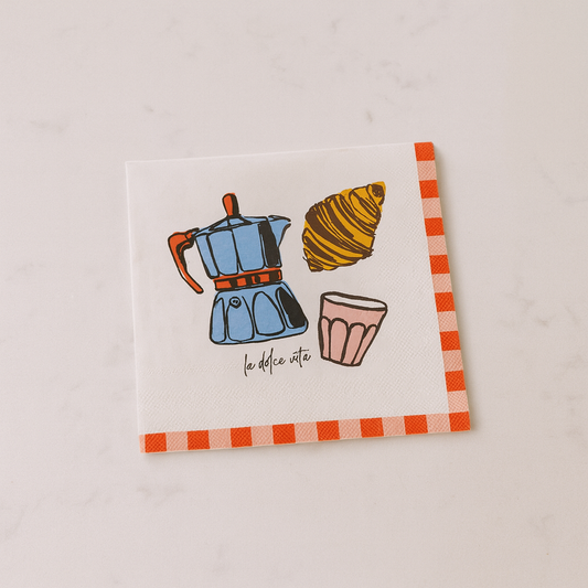 Napkin with coffee maker, croissant, and cup illustration on a light background